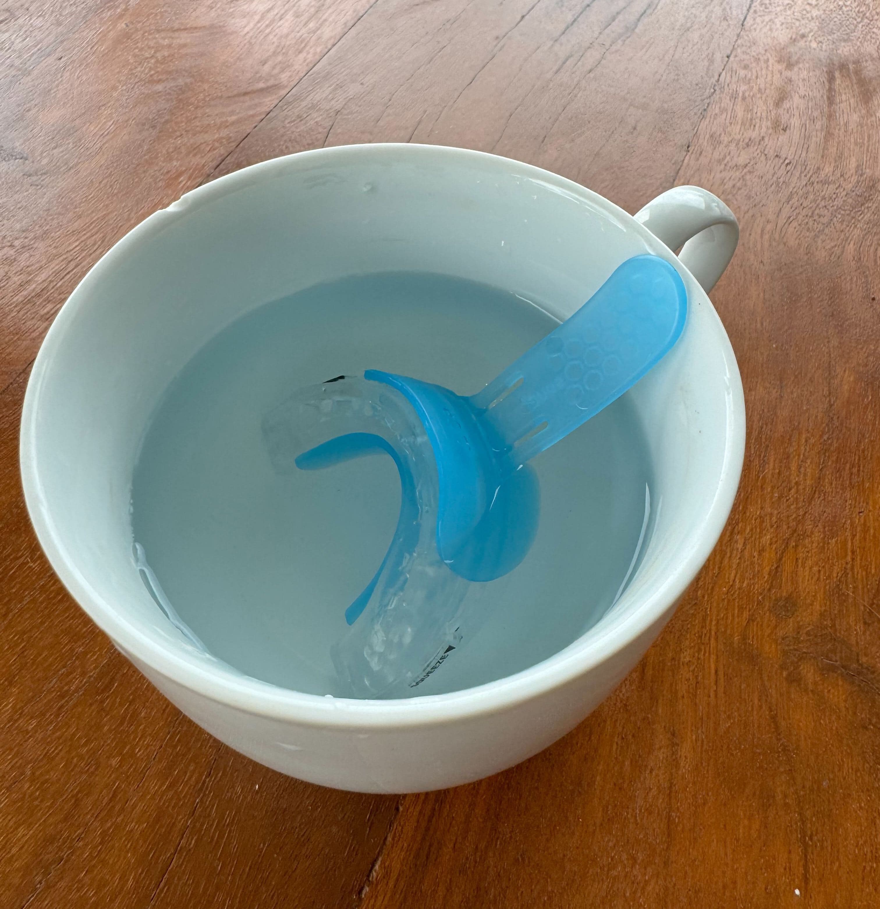 SnoreRx Plus with a water cup